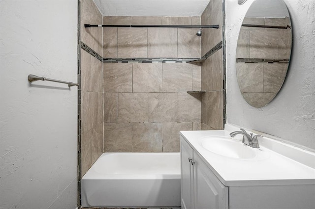 bathroom featuring vanity and tiled shower / bath