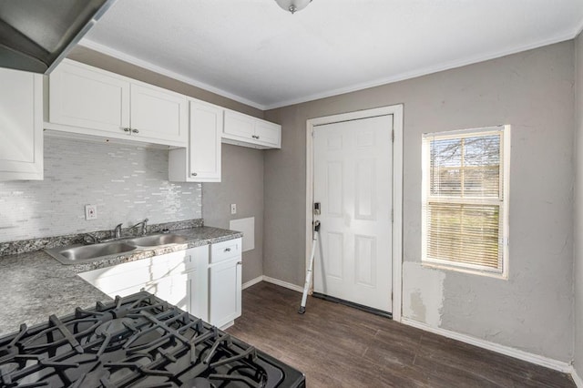 kitchen featuring backsplash, dark wood-type flooring, white cabinets, sink, and gas stove