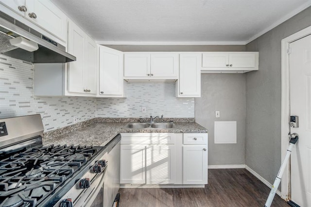 kitchen with white cabinets, appliances with stainless steel finishes, dark hardwood / wood-style flooring, and sink