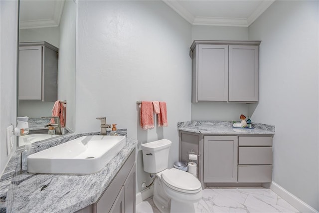 bathroom with vanity, toilet, and ornamental molding