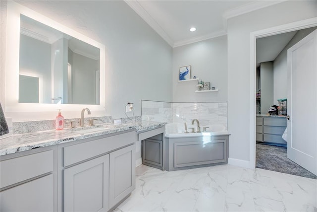 bathroom with vanity, ornamental molding, and a tub