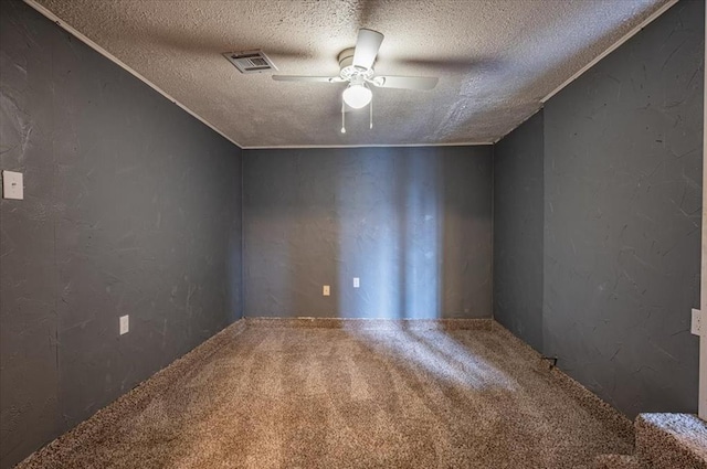 spare room featuring carpet, a textured ceiling, and ceiling fan