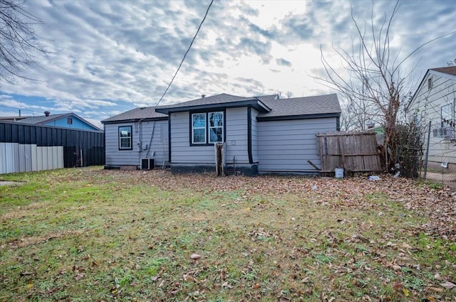 rear view of house with a yard