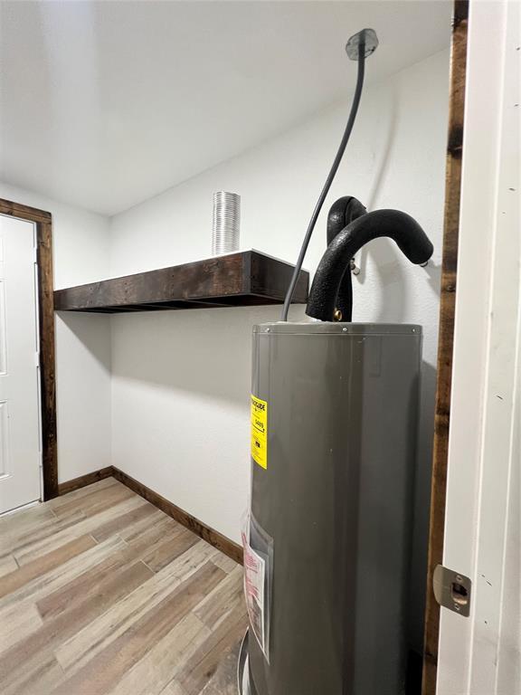 utility room featuring water heater