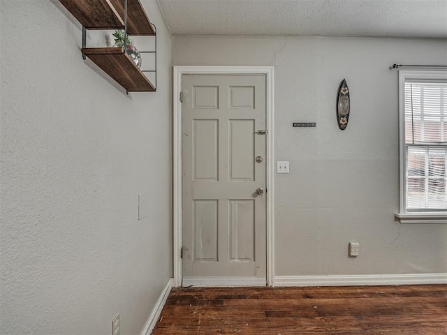 interior space featuring dark hardwood / wood-style floors and a textured ceiling