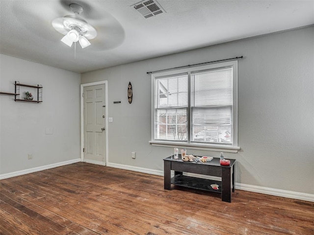 foyer entrance featuring wood-type flooring and ceiling fan