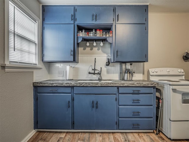 kitchen with blue cabinets, sink, and electric stove