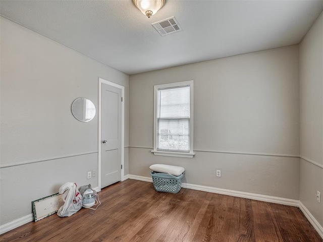 empty room with hardwood / wood-style flooring