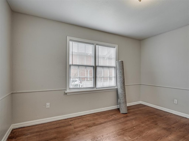 unfurnished room featuring hardwood / wood-style flooring