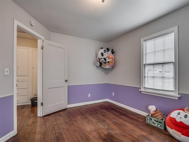 unfurnished bedroom featuring dark hardwood / wood-style floors