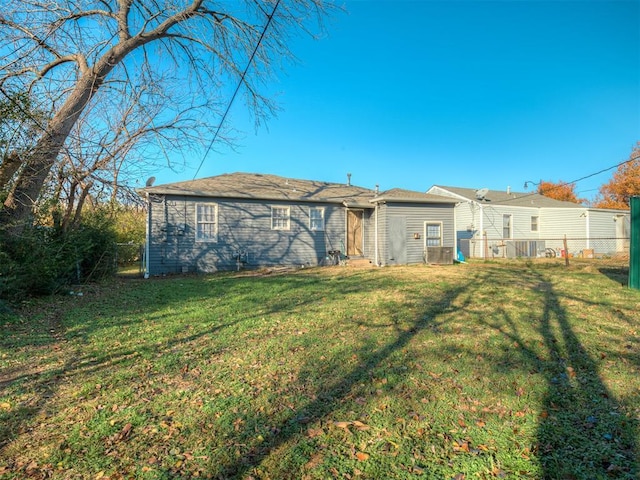 rear view of property featuring a yard