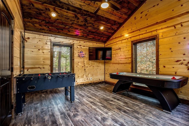 game room with wooden walls, a healthy amount of sunlight, and vaulted ceiling