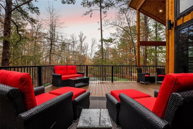 deck at dusk with an outdoor hangout area