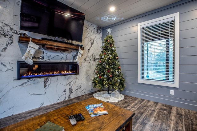 living room with hardwood / wood-style flooring and wooden walls
