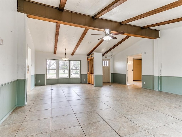 empty room with vaulted ceiling with beams, ceiling fan, and light tile patterned floors