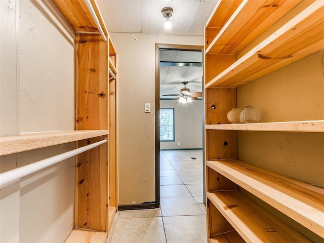 spacious closet featuring ceiling fan and light tile patterned floors