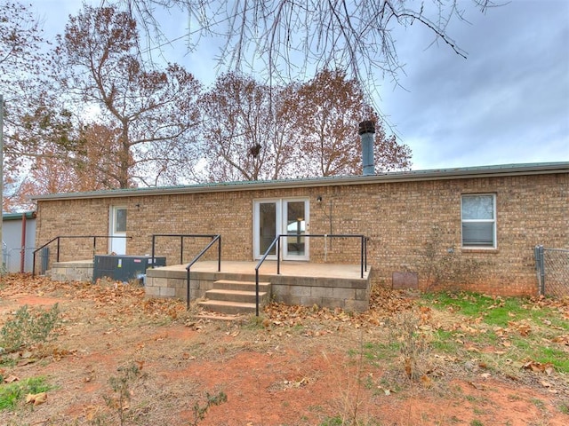 rear view of property with central air condition unit