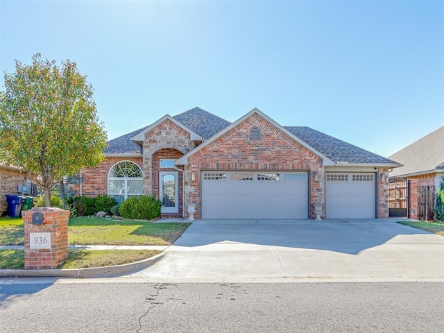 view of front of property with a garage and a front yard