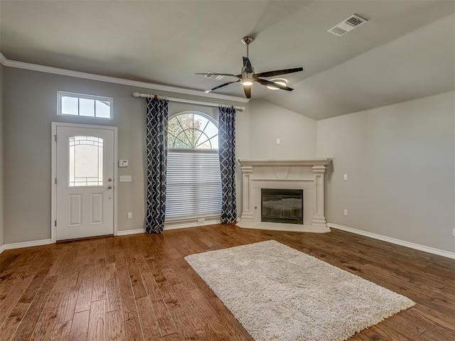 unfurnished living room featuring hardwood / wood-style floors, vaulted ceiling, ceiling fan, and crown molding