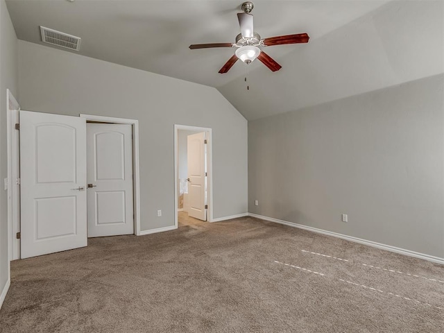 unfurnished bedroom with carpet flooring, ensuite bathroom, ceiling fan, and lofted ceiling