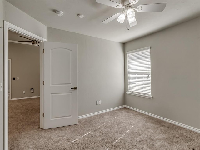 unfurnished bedroom with ceiling fan and light carpet