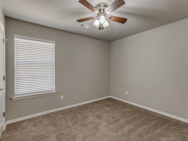 carpeted empty room featuring ceiling fan