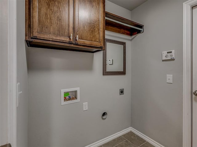 laundry area with hookup for an electric dryer, hookup for a washing machine, tile patterned flooring, and cabinets