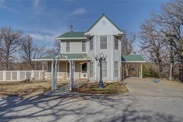 victorian home featuring a carport and covered porch