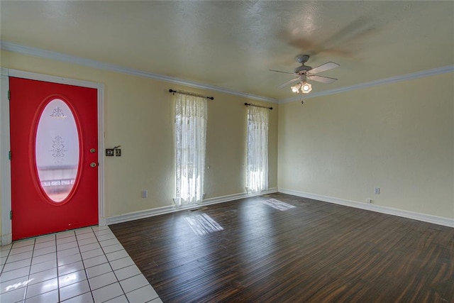 entrance foyer featuring hardwood / wood-style flooring, ceiling fan, and crown molding