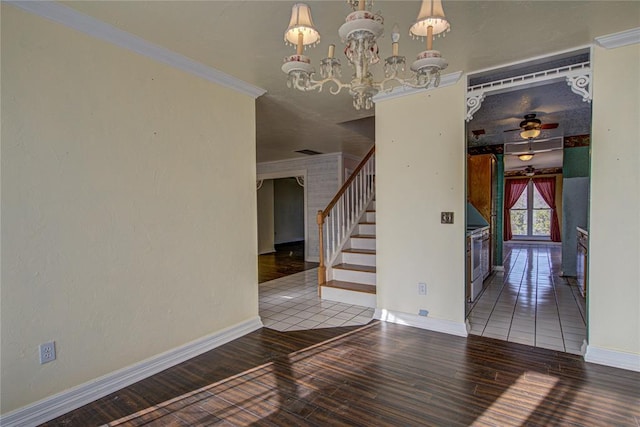 unfurnished room featuring hardwood / wood-style floors, ceiling fan with notable chandelier, and crown molding