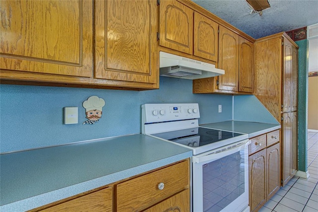 kitchen featuring light tile patterned flooring, electric stove, and a textured ceiling