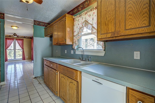 kitchen with a textured ceiling, white dishwasher, ceiling fan, sink, and light tile patterned floors