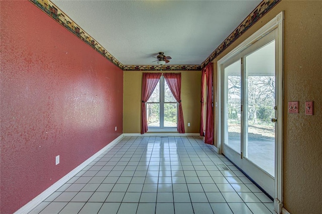 tiled spare room with ceiling fan