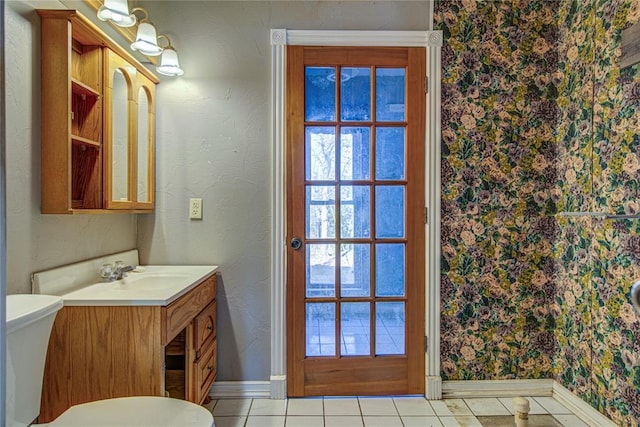 bathroom featuring tile patterned floors, vanity, and toilet