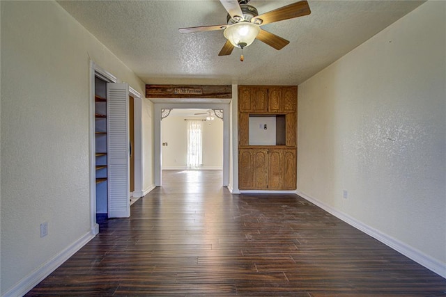 empty room featuring dark hardwood / wood-style flooring and a textured ceiling