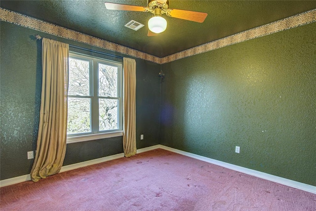 carpeted spare room with ceiling fan and a textured ceiling