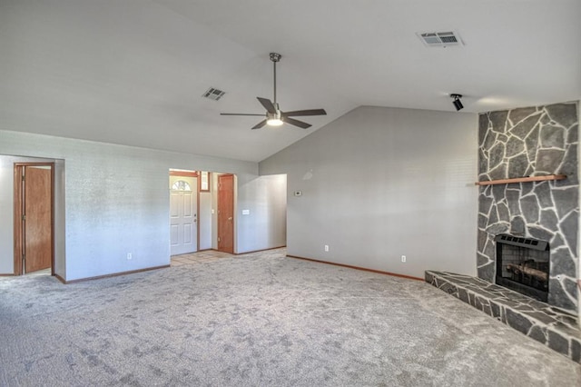 unfurnished living room with carpet floors, a stone fireplace, ceiling fan, and lofted ceiling