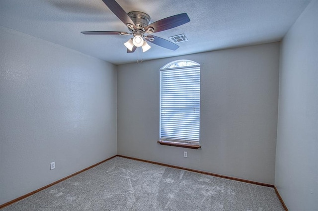 spare room featuring carpet flooring and ceiling fan