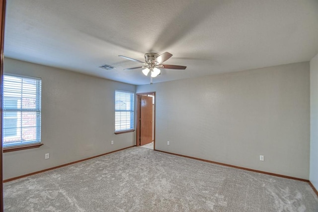 spare room featuring ceiling fan and light colored carpet