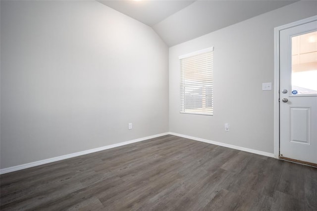 interior space with dark wood-type flooring and vaulted ceiling