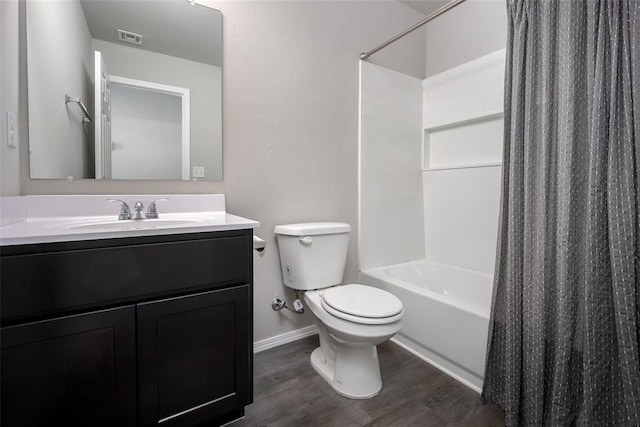 full bathroom with hardwood / wood-style flooring, vanity, toilet, and shower / tub combo