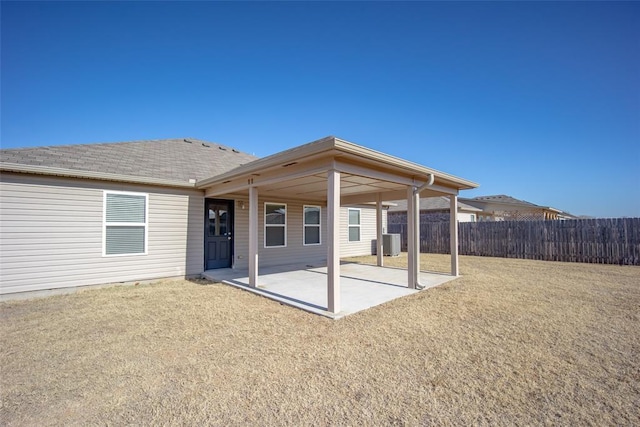 back of property featuring a yard, a patio, and central AC