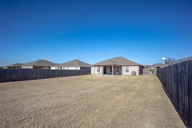 rear view of property with central AC