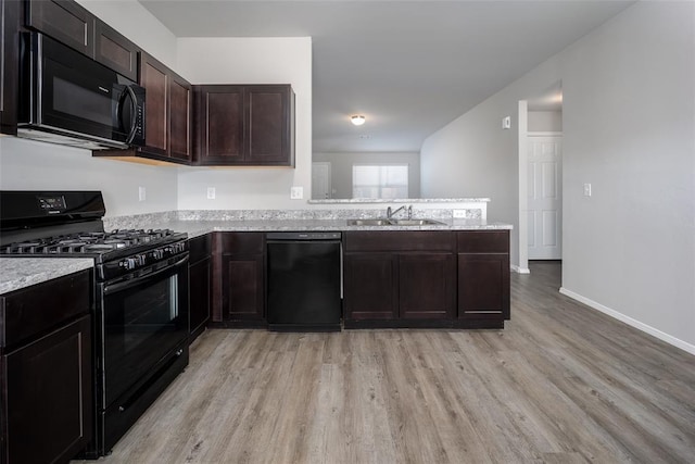 kitchen with black appliances, dark brown cabinets, light hardwood / wood-style floors, and sink