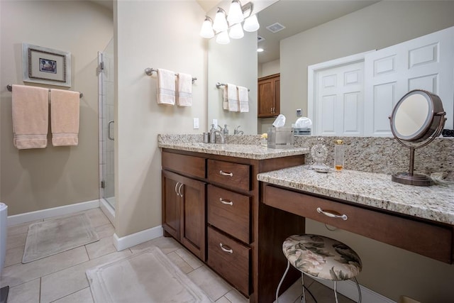 bathroom featuring tile patterned flooring, vanity, and a shower with door