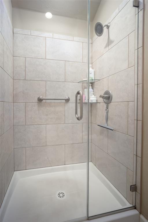 bathroom with a shower with shower door