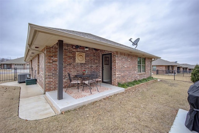 rear view of property featuring a patio area and cooling unit