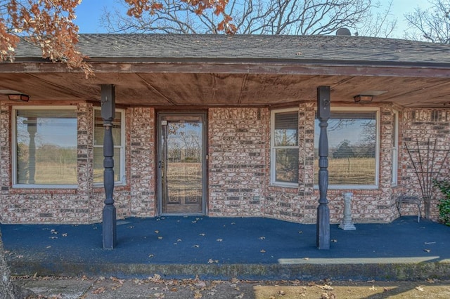 view of exterior entry with covered porch