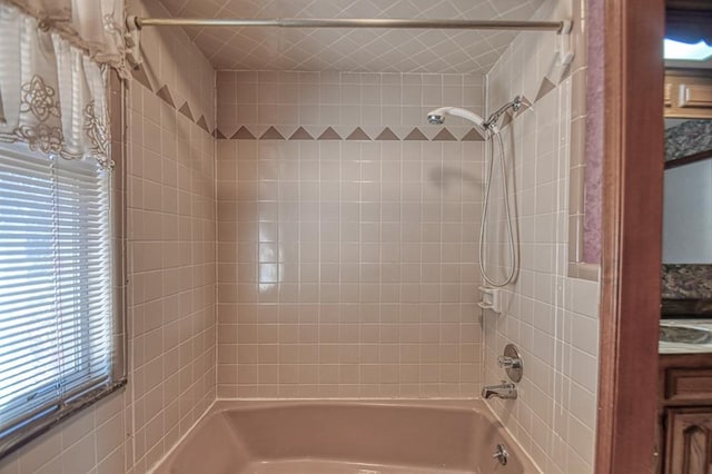 bathroom with vanity and tiled shower / bath combo