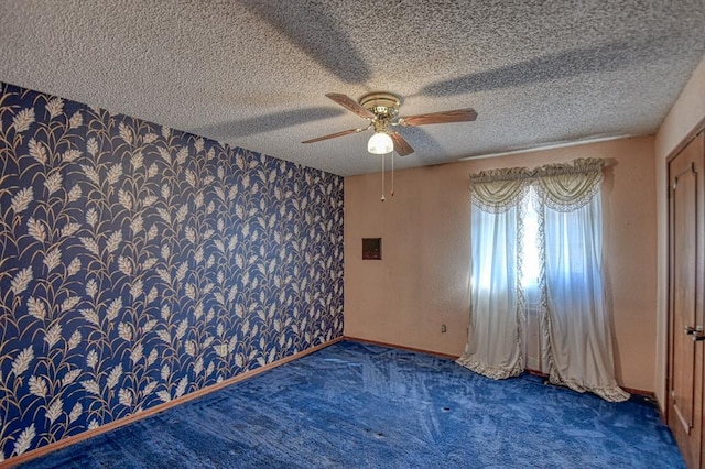 unfurnished room featuring ceiling fan and a textured ceiling